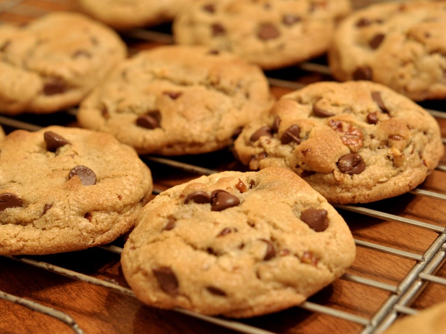Chocolate chip cookies cooling on a wire rack.